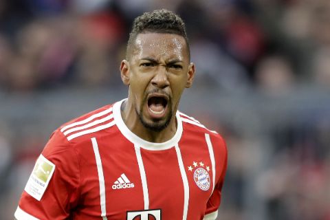 Jerome Boateng poses a picture in a Bayern Munich shirt.